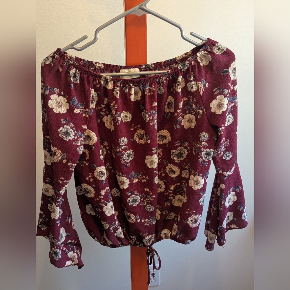Women's flowered top with bell sleeves.